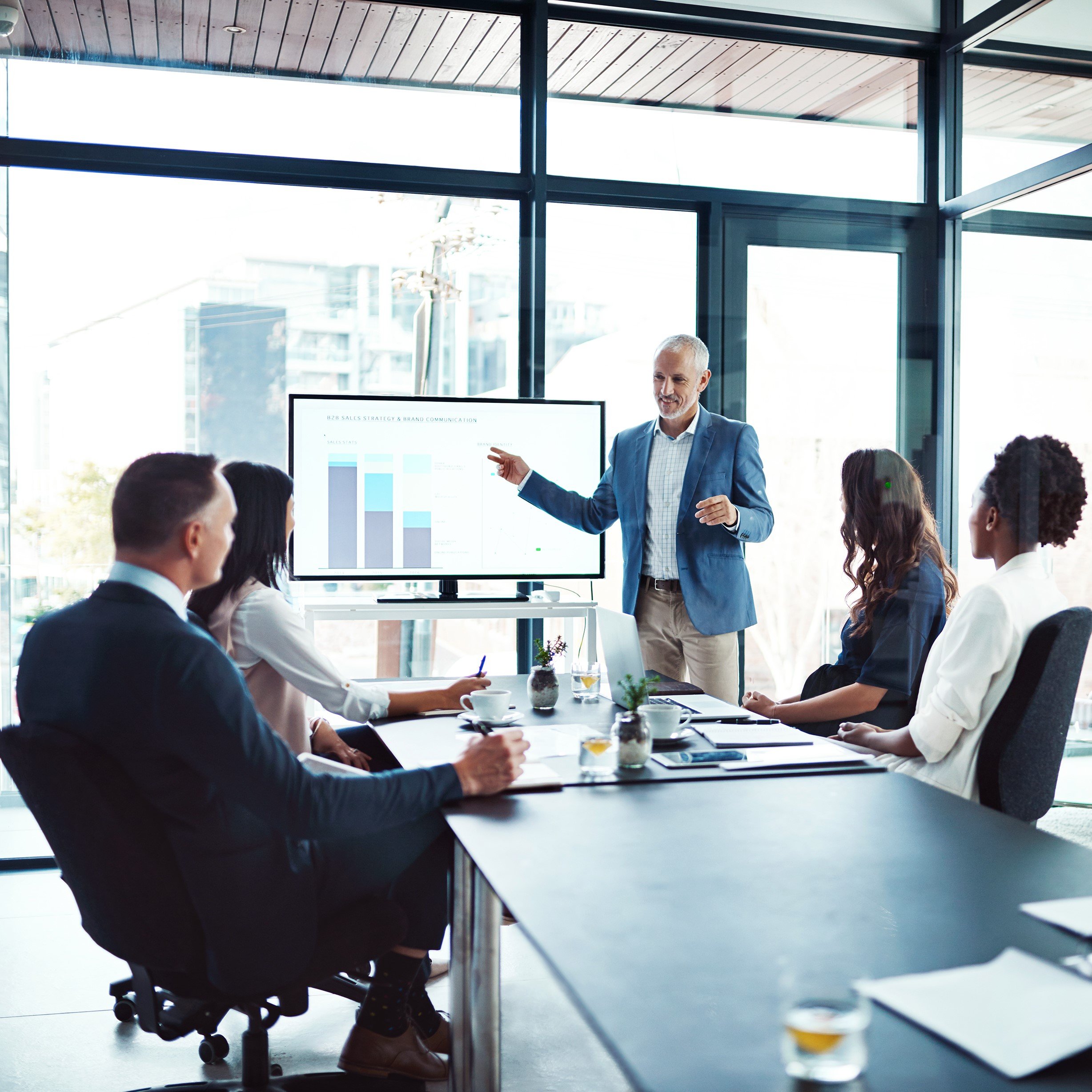 Members of an executive team hold a meeting in a conference room