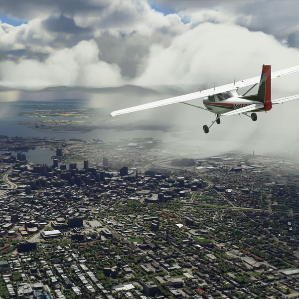 Small aircraft flying over a city