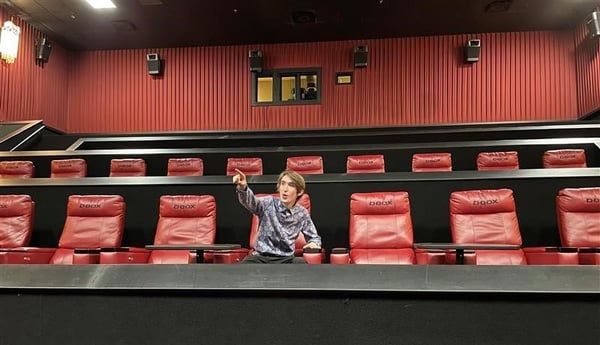 Tanya Fenner, Cinemark manager, seated in a movie theater with D-BOX seats
