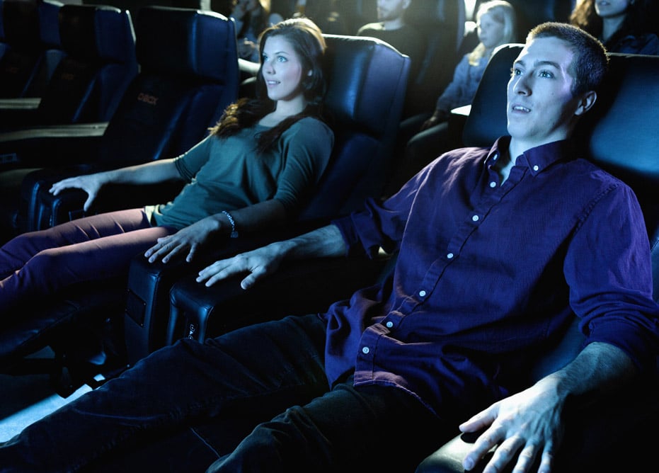 Couple enjoying recliner seats in a movie theater