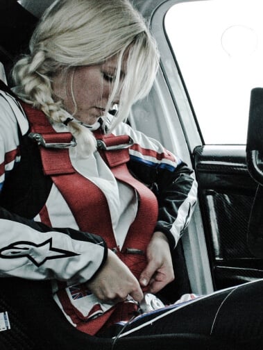 British rally Driver Louise Cook buckles herself in her car